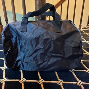 Brand new black duffel bag with outside zipper and top zipper